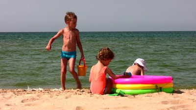 stock-footage-group-children-play-on-beach