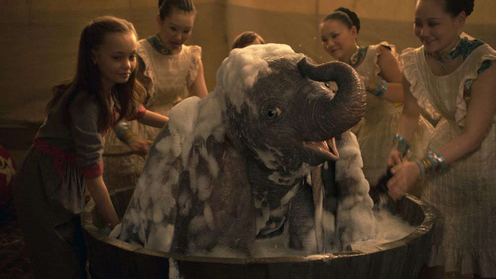 BATHTIME -- In Disney’s live-action reimagining of “Dumbo,” Milly Farrier—the daughter of a former circus star charged with caring for a newborn elephant—quickly embraces the newest member of their circus family. Featuring Nico Parker as Milly, “Dumbo” opens in U.S. theaters on March 29, 2019...© 2019 Disney Enterprises, Inc. All Rights Reserved.